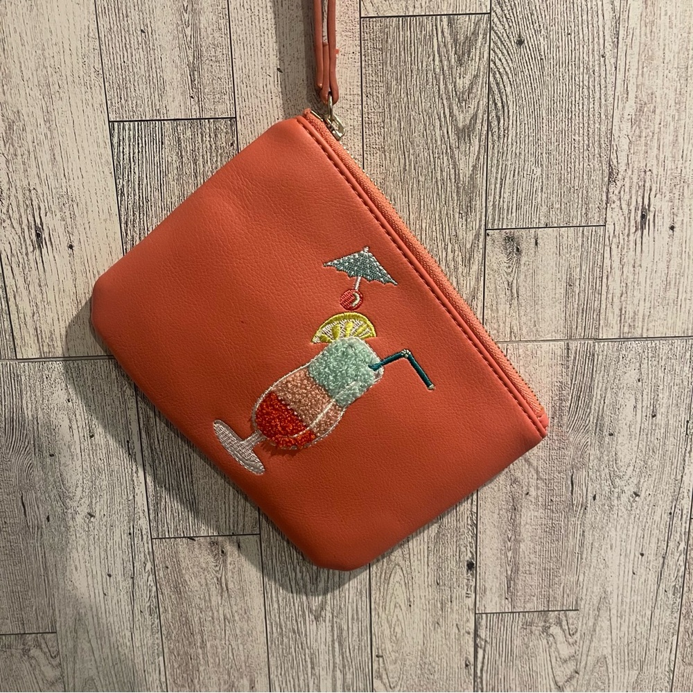 Small zipper clutch bag with wrist strap, coral color